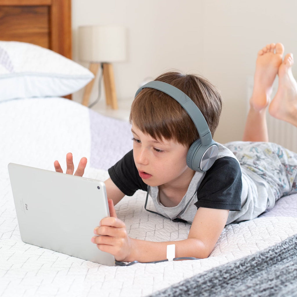 Boy watching an ipad and wearing headphones